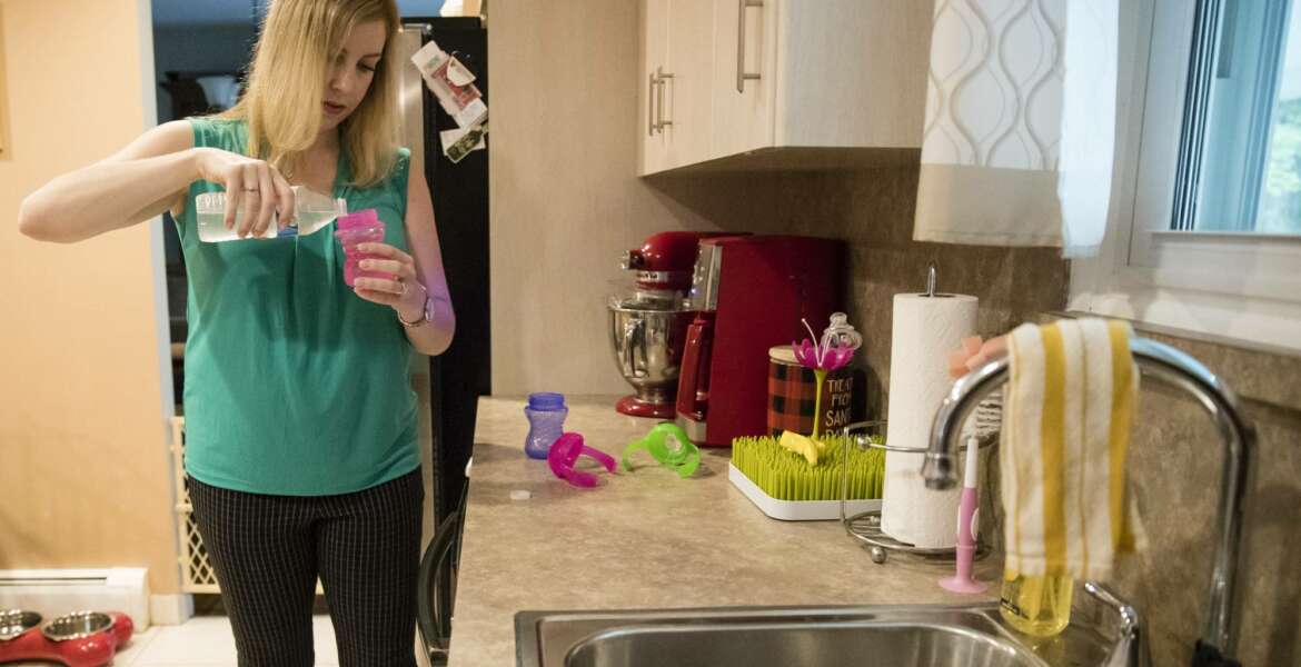 In this Aug. 1, 2018 photo, Lauren Woehr pours bottled water into her 16-month-old daughter Caroline's cup at their home in Horsham, Pa. In Horsham and surrounding towns in eastern Pennsylvania, and at other sites around the United States, the foams once used routinely in firefighting training at military bases contained per-and polyfluoroalkyl substances, or PFAS. EPA testing between 2013 and 2015 found significant amounts of PFAS in public water supplies in 33 U.S. states. (AP Photo/Matt Rourke)