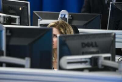 A worker is surrounded by computer monitors in the Department of Homeland Security's National Cybersecurity and Communications Integration Center (NCCIC) in Arlington, Va., Wednesday, Aug. 22, 2018. The center serves as the hub for the federal government's cyber situational awareness, incident response, and management center for any malicious cyber activity. (AP Photo/Cliff Owen)