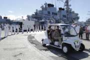 File - In this June 19, 2018, file photo, with sailors lining the dock and deck of the USS O'Kane, Pearl Harbor survivor Ray Emory, center, arrives at a surprise ceremony honoring him in Honolulu. Emory, who pushed for the remains of those buried as unknowns to be identified, has died. He was 97. He spent the past few decades doggedly pushing for the remains of those buried as unknowns to be dug up, identified and returned to their families. A spokesman for Navy Region Hawaii says according to family members, Emory died Monday, Aug. 20, 2018, in a hospital in Boise, Idaho. (AP Photo/Marco Garcia, File)