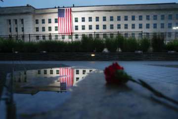 A U.S. flag is unfurled at sunrise on Tuesday, Sept. 11, 2018, at the Pentagon on the 17th anniversary of the Sept. 11, 2001, terrorist attacks. (AP Photo/Pablo Martinez Monsivais)