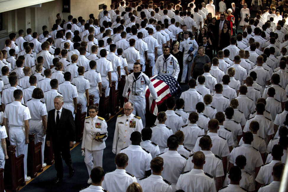 In this image proved by the U.S. Navy, Defense Secretary Jim Mattis, left, leads as the family follows as the casket of Sen. John McCain, R-Ariz., is moved from the Chapel on the grounds of the United States Navel Academy after a service Sunday, Sept. 2, 2018, in Annapolis, Md. The casket was carried by horse-drawn caisson to the cemetery at the Naval Academy where McCain was buried.  (Mass Communication Specialist 2nd Class Nathan Burke/U.S. Navy via AP)