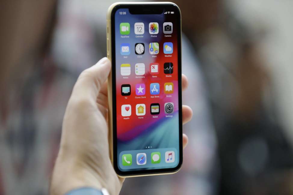 The new Apple iPhone XR is on display at the Steve Jobs Theater after an event to announce new products Wednesday, Sept. 12, 2018, in Cupertino, Calif. (AP Photo/Marcio Jose Sanchez)