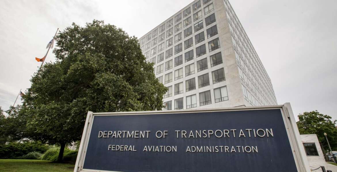 FILE - In this June 19, 2015 file photo, Department of Transportation Federal Aviation Administration building is seen in Washington. The FAA would be required to set new minimum requirements for seats on airplanes under legislation to be considered in the House this week. The regulation of seat width and legroom is part of a five-year extension of federal aviation programs agreed to early Saturday, Sept. 22, 2018, by Republican and Democratic leaders of the House and Senate committees that oversee the nation's air travel. (AP Photo/Andrew Harnik, File)