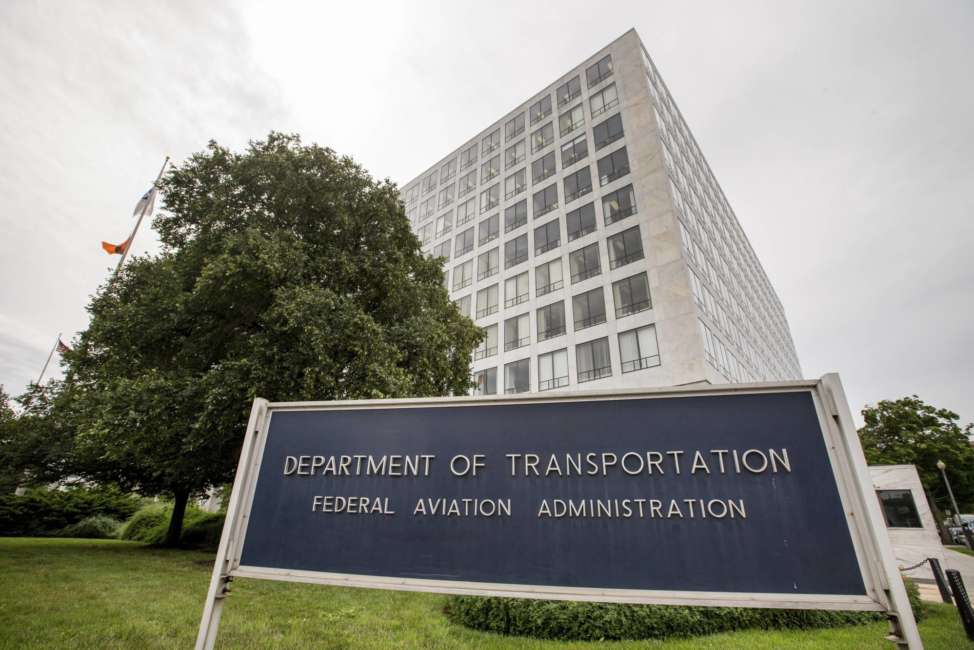 FILE - In this June 19, 2015 file photo, Department of Transportation Federal Aviation Administration building is seen in Washington. The FAA would be required to set new minimum requirements for seats on airplanes under legislation to be considered in the House this week. The regulation of seat width and legroom is part of a five-year extension of federal aviation programs agreed to early Saturday, Sept. 22, 2018, by Republican and Democratic leaders of the House and Senate committees that oversee the nation's air travel. (AP Photo/Andrew Harnik, File)