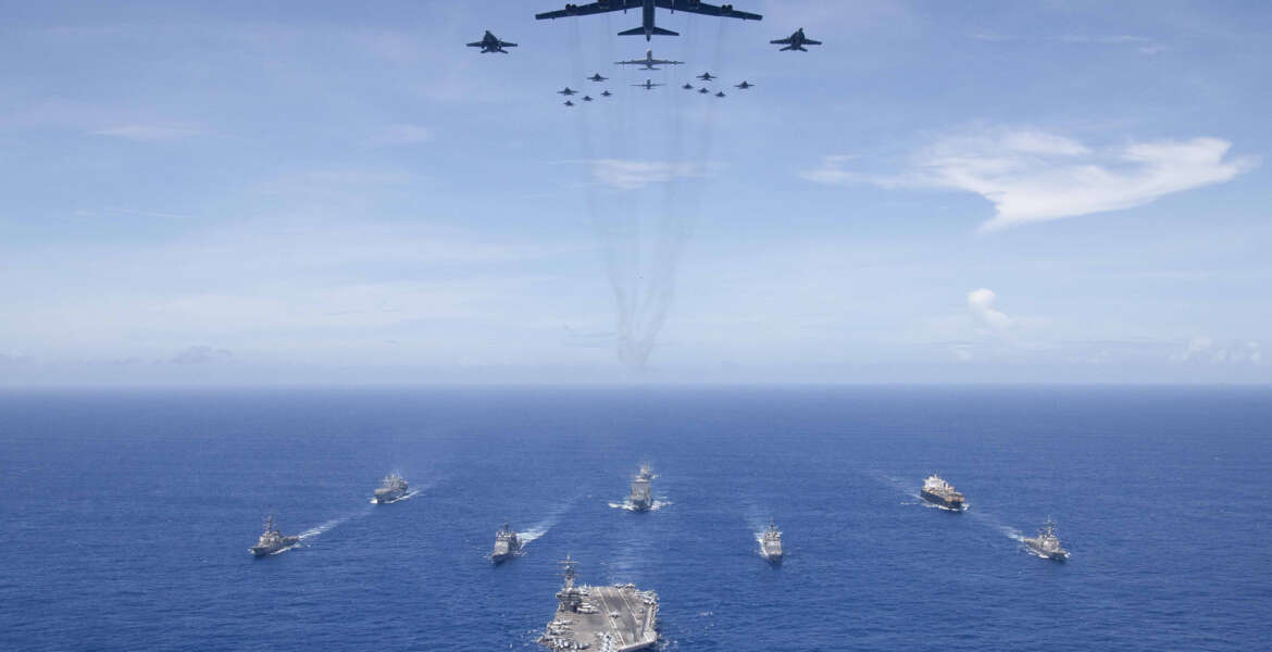 PHILIPPINE SEA (Sept. 17, 2018) The aircraft carrier USS Ronald Reagan (CVN 76) leads a formation of Carrier Strike Group (CSG) 5 ships as U.S. Air Force B-52 Stratofortress aircraft and U.S. Navy F/A-18 Hornets pass overhead for a photo exercise during Valiant Shield 2018. The biennial, U.S. only, field-training exercise focuses on integration of joint training among the U.S. Navy, Air Force and Marine Corps.