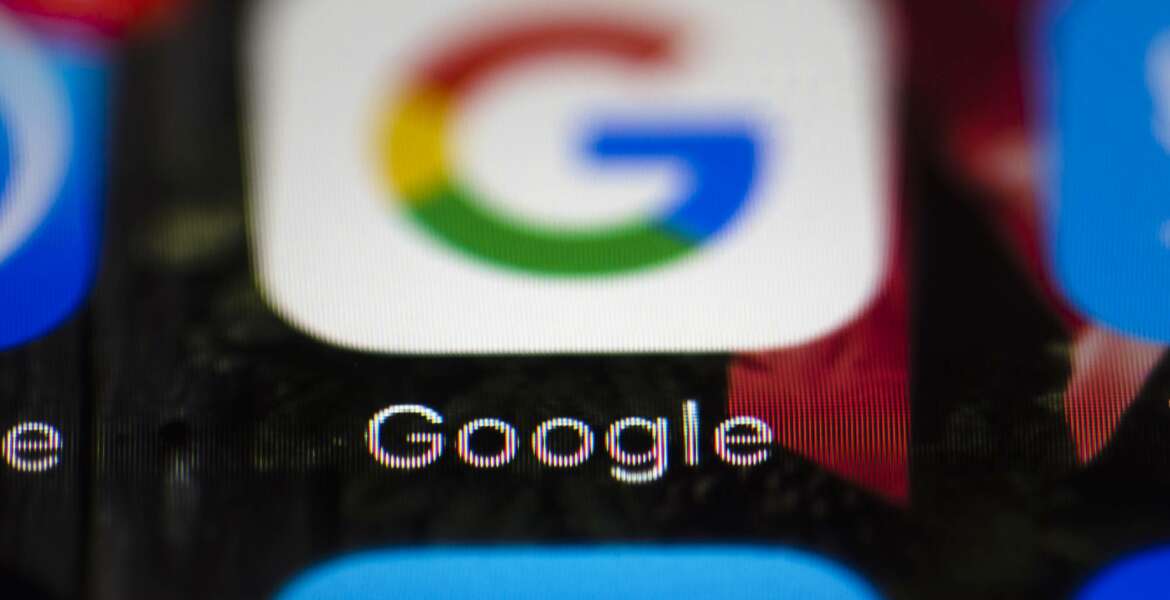 FILE- This April 26, 2017, file photo shows a Google icon on a mobile phone in Philadelphia. New Mexico is suing Google, Twitter and other companies that develop and market mobile gaming apps for children, saying the apps violate state and federal laws by collecting personal information that could compromise privacy. The lawsuit filed in federal court late Tuesday, Sept. 11, 2018, comes as data-sharing concerns persist among users. (AP Photo/Matt Rourke, File)