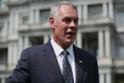 WASHINGTON, DC - AUGUST 16:  Interior Secretary Ryan Zinke talks to journalists outside the White House West Wing before attending a cabinet meeting with President Donald Trump August 16, 2018 in Washington, DC. Zinke said the historic wild fires in the west are caused by mismanaged public lands and 