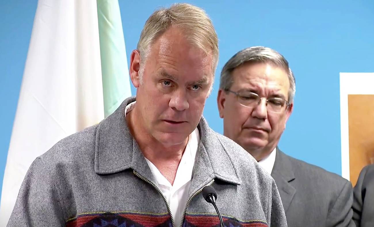 In this image made from a WLOS-TV livestream, Interior Secretary Ryan Zinke addresses reporters at a news conference on Thursday, Sept. 27, 2018, in Asheville, N.C. Zinke was announcing that 76 people were arrested on drug charges in a sweep of traffickers on western North Carolina tribal land in a sweep by federal, state and local officers. (WLOS-TV via AP)