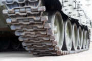 Iron caterpillars and wheels of the military heavy tank. Close up