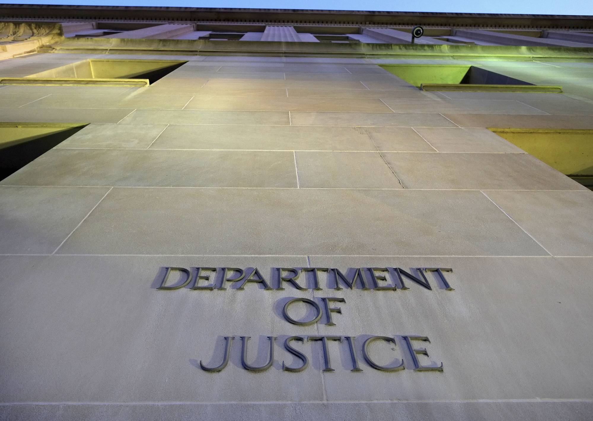 FILE - In this May 14, 2013, file photo, the Department of Justice headquarters building in Washington is photographed early in the morning. The Trump administration has stepped up scrutiny of asbestos trust funds out of concern of fraud and abuse. The Justice Department worries the pots of money intended to help people exposed to the hazardous substance are being depleted by fraudulent claims _ harming victims, businesses and the government. (AP Photo/J. David Ake, File)