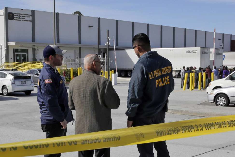 Postal inspectors confer outside of a postal facility in Burlingame, Calif., on Friday, Oct. 26. 2018. FBI spokesman Prentice Danner says a suspicious package seized at this facility near San Francisco and addressed to billionaire political activist Tom Steyer has several similarities to 13 explosive devices that were addressed to prominent Democrats across the country. When asked if authorities believe the package found Friday is related to the others, Danner said the "timing and addressee would tell us yes.". (AP Photo/Stephanie Mullen)