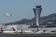 FILE - In this Oct. 24, 2107 file photo, the air traffic control tower is in sight as a plane takes off from San Francisco International Airport in San Francisco. Aviation-safety officials say a close call last year highlights the need for faster reporting of dangerous incidents before evidence is lost. The National Transportation Safety Board issued a final report Thursday, Oct. 11, 2018  on the July 2017 close call in which an Air Canada jet nearly crashed into planes lined up on the ground at San Francisco International Airport. (AP Photo/Jeff Chiu, File)