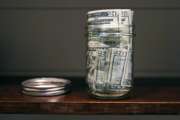 FILE - In this June 15, 2018, file photo a canning jar filled with currency sits on a shelf in East Derry, N.H. The idea of having enough money to hire a financial adviser seems like a dream for many. Fortunately, there are less expensive, even free, ways to take a do-it-yourself approach to managing and growing your money. (AP Photo/Charles Krupa, File)