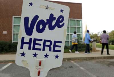 FILE- In this Oct. 23, 2018, file photo people arrive for early voting at a polling place in Charlotte, N.C. Companies aren’t required to shut down on Nov. 6, for the election, but many give their staffers paid time off to go to the polls , 44 percent, according to a survey by the Society for Human Resources Management, a trade group. Small business owners who wonder what to do should first check their state and local laws. (AP Photo/Chuck Burton, File)