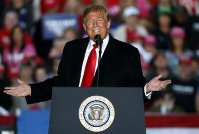 In this Oct. 27, 2018, photo, President Donald Trump speaks during a rally at Southern Illinois Airport in Murphysboro, Ill. Eager to focus voters on immigration in the lead-up to the midterm elections, Trump on Oct. 29 escalated his threats against a migrant caravan trudging slowly toward the U.S. border as the Pentagon prepared to deploy thousands of U.S. troops to support the border patrol. (AP Photo/Jeff Roberson)