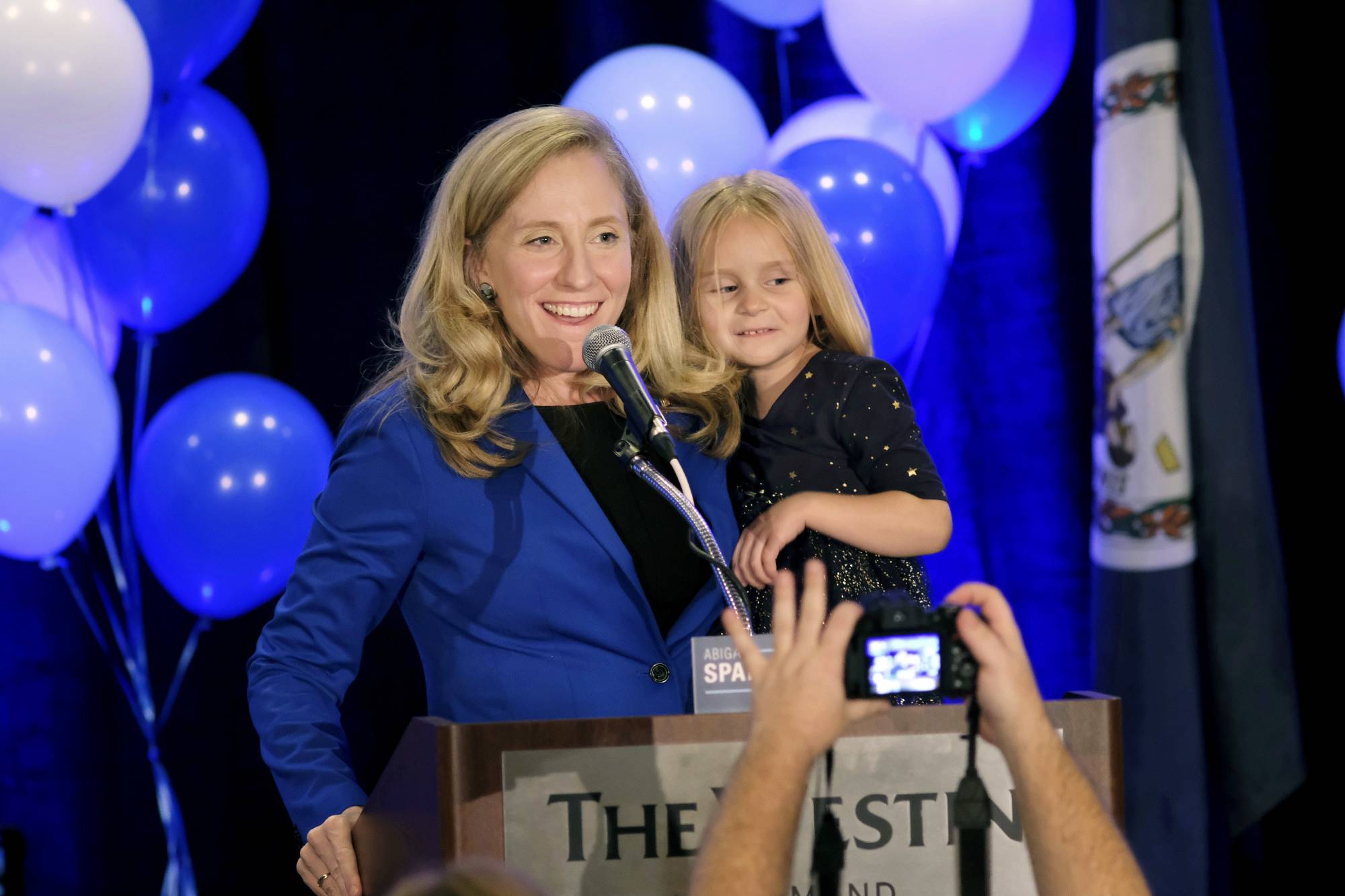 Democrat Abigail Spanberger claims victory in the 7th district Virginia congressional race while holding her daughter Catherine, 4, during a victory party in Richmond, Va., late Tuesday, Nov. 6, 2018. She defeated two-term Republican congressman Dave Brat. (Dean Hoffmeyer/Richmond Times-Dispatch via AP)
