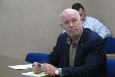 In this Tuesday, Oct. 9, 2018 photo Rep. Greg Gianforte listens during a meeting with leaders from the Montana Department of Justice and Montana Highway Patrol in Helena, Mont.. Gianforte is running against Democratic challenger Kathleen Williams to keep the congressional seat he won last year in a special election. (AP Photo/Matt Volz)