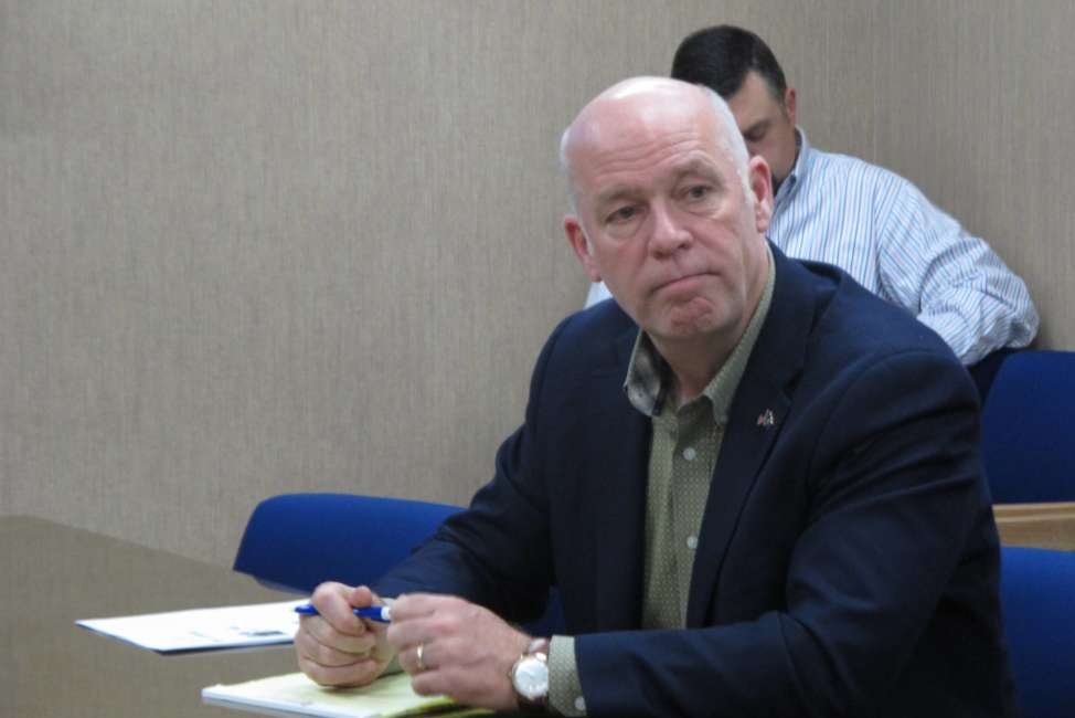 In this Tuesday, Oct. 9, 2018 photo Rep. Greg Gianforte listens during a meeting with leaders from the Montana Department of Justice and Montana Highway Patrol in Helena, Mont.. Gianforte is running against Democratic challenger Kathleen Williams to keep the congressional seat he won last year in a special election. (AP Photo/Matt Volz)