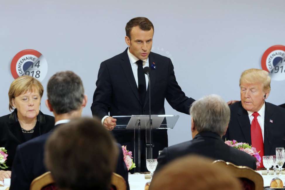 German Chancellor Angela Merkel and President Donald Trump listen to French President Emmanuel Macron delivering a speech before a lunch at the Elysee Palace in Paris during commemorations marking the 100th anniversary of the 11 November 1918 armistice, ending World War I, Sunday, Nov. 11, 2018. (Jacques Demarthon/Pool Photo via AP)