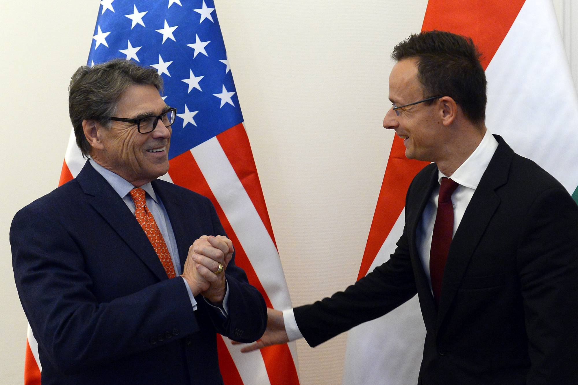 Hungarian Minister of Foreign Affairs and Trade Peter Szijjarto, right, welcomes US Secretary of Energy Rick Perry at the Ministry of Foreign Affairs and Trade in Budapest, Hungary, Tuesday, Nov. 13, 2018. (Lajos Soos/MTI via AP)