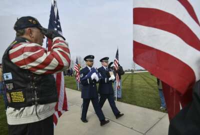 Honor guards from the US Air Force carry the creamated remains of veterans found at Cantrel Funeral home during a full military ceremony at the Great Lakes National Cemetery in Holly on Monday, Nov 12, 2018. About 20 Patriot Guard Riders lined the walk with flags for the ceremony. (Dale G.Young /Detroit News via AP)
