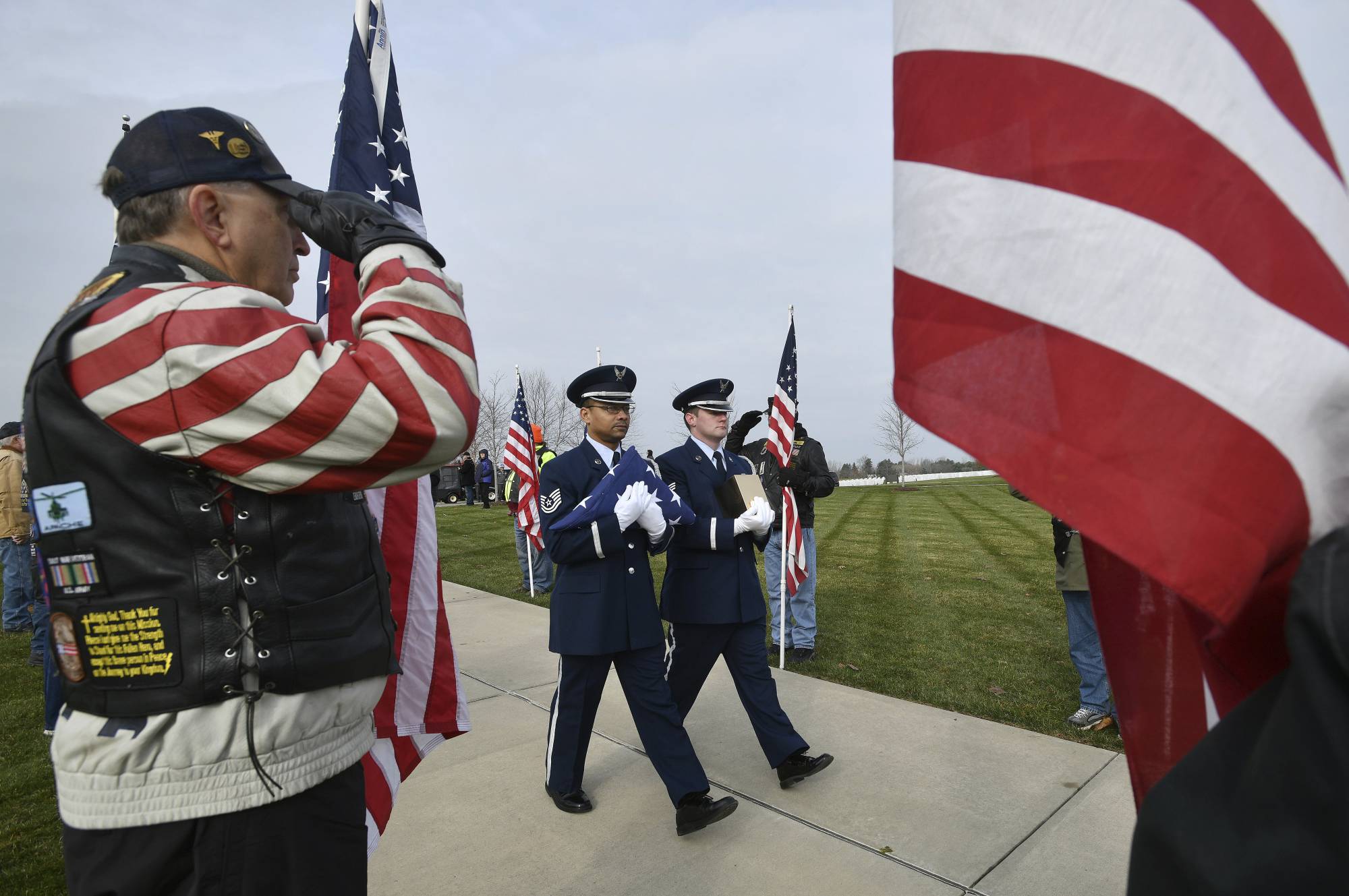 Honor guards from the US Air Force carry the creamated remains of veterans found at Cantrel Funeral home during a full military ceremony at the Great Lakes National Cemetery in Holly on Monday, Nov 12, 2018. About 20 Patriot Guard Riders lined the walk with flags for the ceremony. (Dale G.Young /Detroit News via AP)