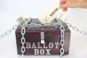 A ballot box, locked and chained to prevent any voter tampering