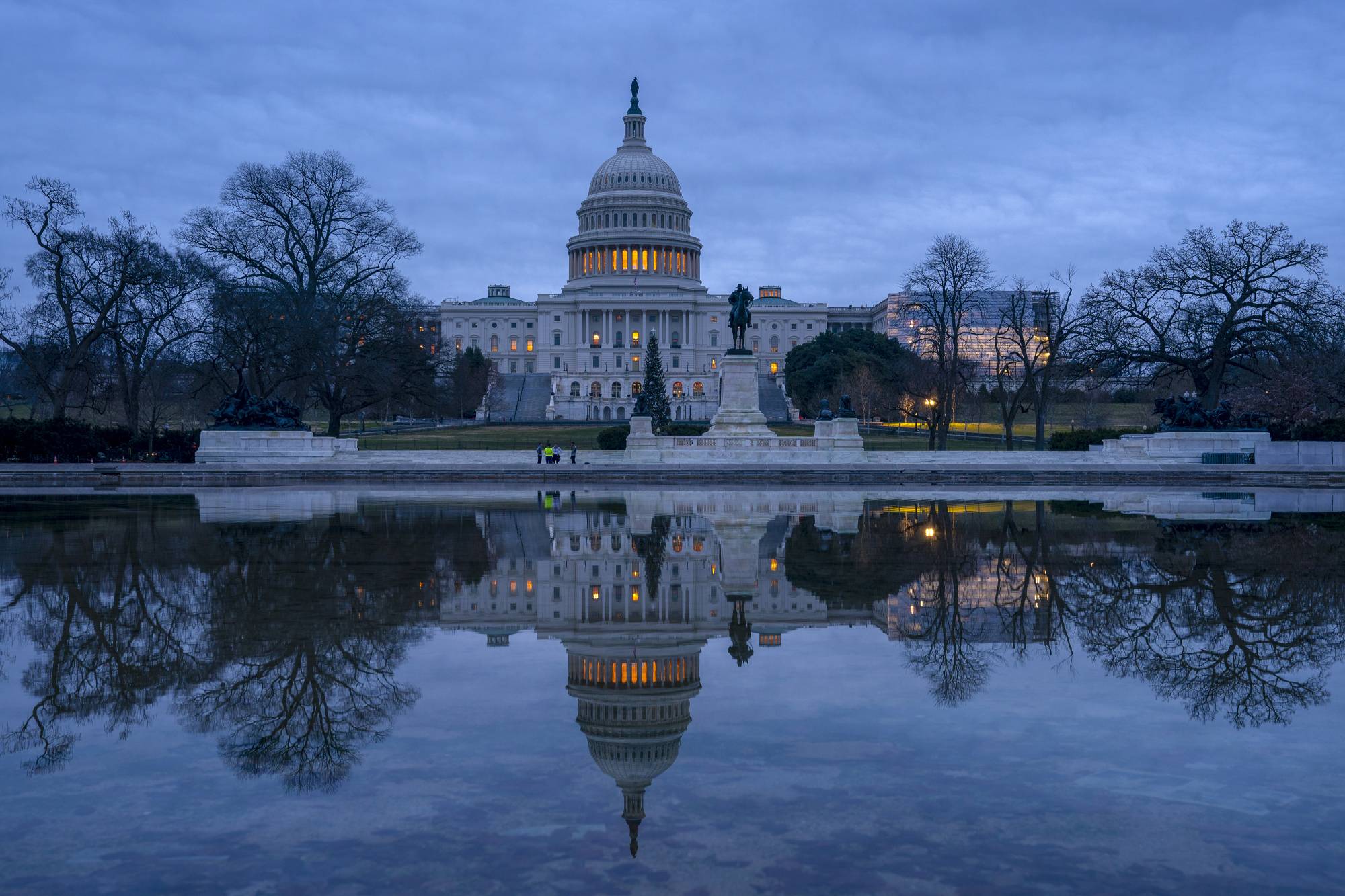 The Capitol is seen under early morning skies in Washington, Thursday, Dec. 20, 2018. The Senate approved legislation to temporarily fund the government late last night, a key step toward averting a federal shutdown after President Donald Trump backed off his demand for money for a border wall with Mexico.  The House is expected to vote before Friday's deadline, when funding for a portion of the government expires. Without resolution, more than 800,000 federal workers would face furloughs or be forced to work without pay, disrupting government operations days before Christmas. (AP Photo/J. Scott Applewhite)