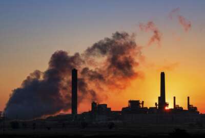 In this July 27, 2018 photo, the Dave Johnson coal-fired power plant is silhouetted against the morning sun in Glenrock, Wyo. The Environmental Protection Agency is proposing to roll back another coal regulation, this one for new coal plants. (AP Photo/J. David Ake)