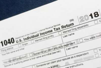 FILE- This July 24, 2018, file photo shows a portion of the 1040 U.S. Individual Income Tax Return form for 2018 in New York. A new rule caps the state and local taxes you can deduct on your federal tax return. That could make more of your income taxable this year, but finding out if the cap affects you, pouncing on other tax breaks, bunching your charitable contributions and planning for a new tax world could help. (AP Photo/Mark Lennihan, File)