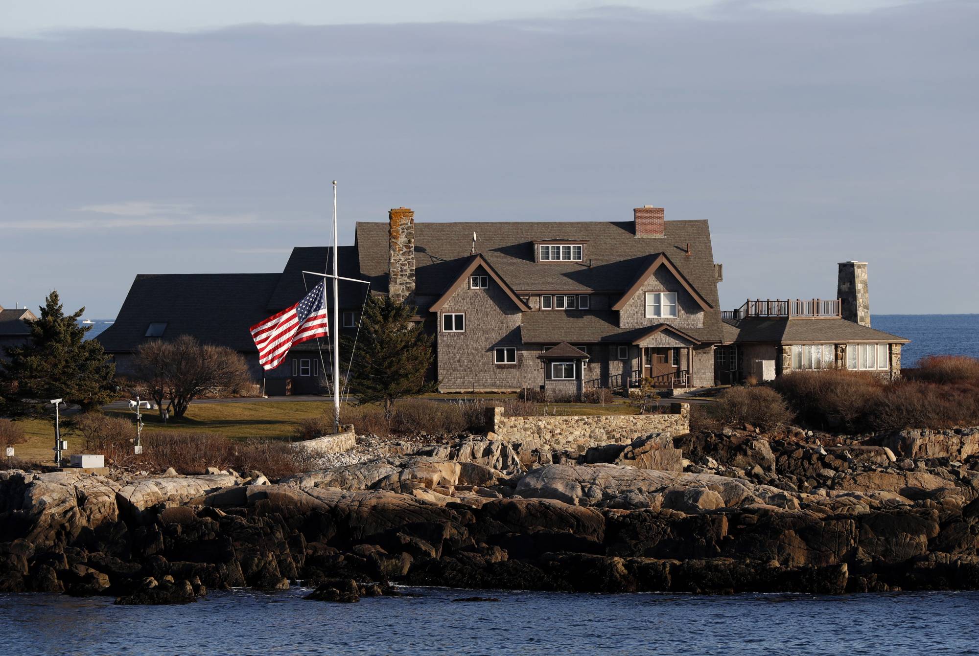 The American flag flies at half-staff in honor of President George H. W. Bush at Walker's Point, the Bush's summer home, Saturday, Dec. 1, 2018, in Kennebunkport, Maine. Bush died at the age of 94 on Friday, about eight months after the death of his wife, Barbara Bush. (AP Photo/Robert F. Bukaty)