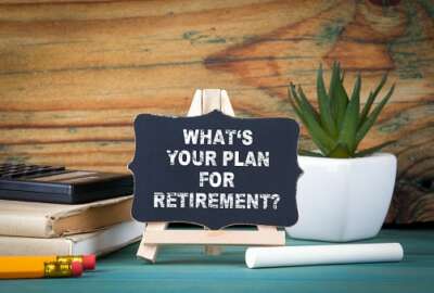 What's Your Plan for Retirement. small wooden board with chalk on the table