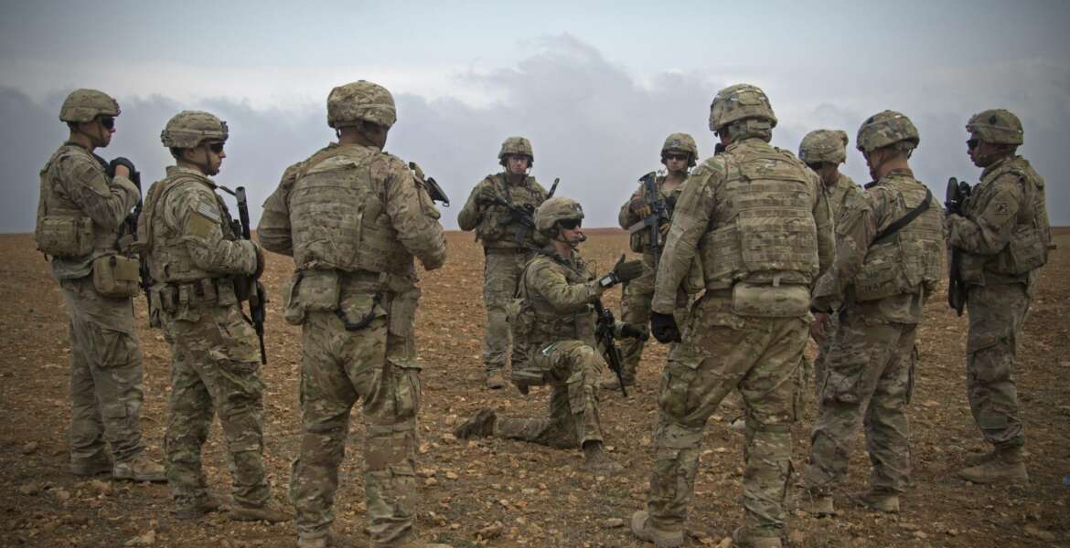 In this Nov. 7, 2018, photo released by the U.S. Army, U.S. soldiers gather for a brief during a combined joint patrol rehearsal in Manbij, Syria. The United States’ main ally in Syria on Thursday, Dec. 20, 2018, rejected President Donald Trump’s claim that Islamic State militants have been defeated and warned that the withdrawal of American troops would lead to a resurgence of the extremist group. (U.S. Army photo by Spc. Zoe Garbarino via AP)