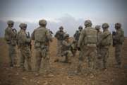 In this Nov. 7, 2018, photo released by the U.S. Army, U.S. soldiers gather for a brief during a combined joint patrol rehearsal in Manbij, Syria. The United States’ main ally in Syria on Thursday, Dec. 20, 2018, rejected President Donald Trump’s claim that Islamic State militants have been defeated and warned that the withdrawal of American troops would lead to a resurgence of the extremist group. (U.S. Army photo by Spc. Zoe Garbarino via AP)