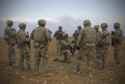 In this Nov. 7, 2018, photo released by the U.S. Army, U.S. soldiers gather for a brief during a combined joint patrol rehearsal in Manbij, Syria. The United States’ main ally in Syria on Thursday, Dec. 20, 2018, rejected President Donald Trump’s claim that Islamic State militants have been defeated and warned that the withdrawal of American troops would lead to a resurgence of the extremist group. (U.S. Army photo by Spc. Zoe Garbarino via AP)
