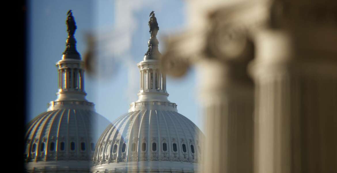 The U.S. Capitol Building Dome is seen through a beveled window at the Library of Congress in Washington, Wednesday, Dec. 19, 2018. President Donald Trump this week appears likely to pass up his last, best chance to secure funding for the “beautiful” wall he’s long promised to construct along the U.S.-Mexico border. (AP Photo/Carolyn Kaster)