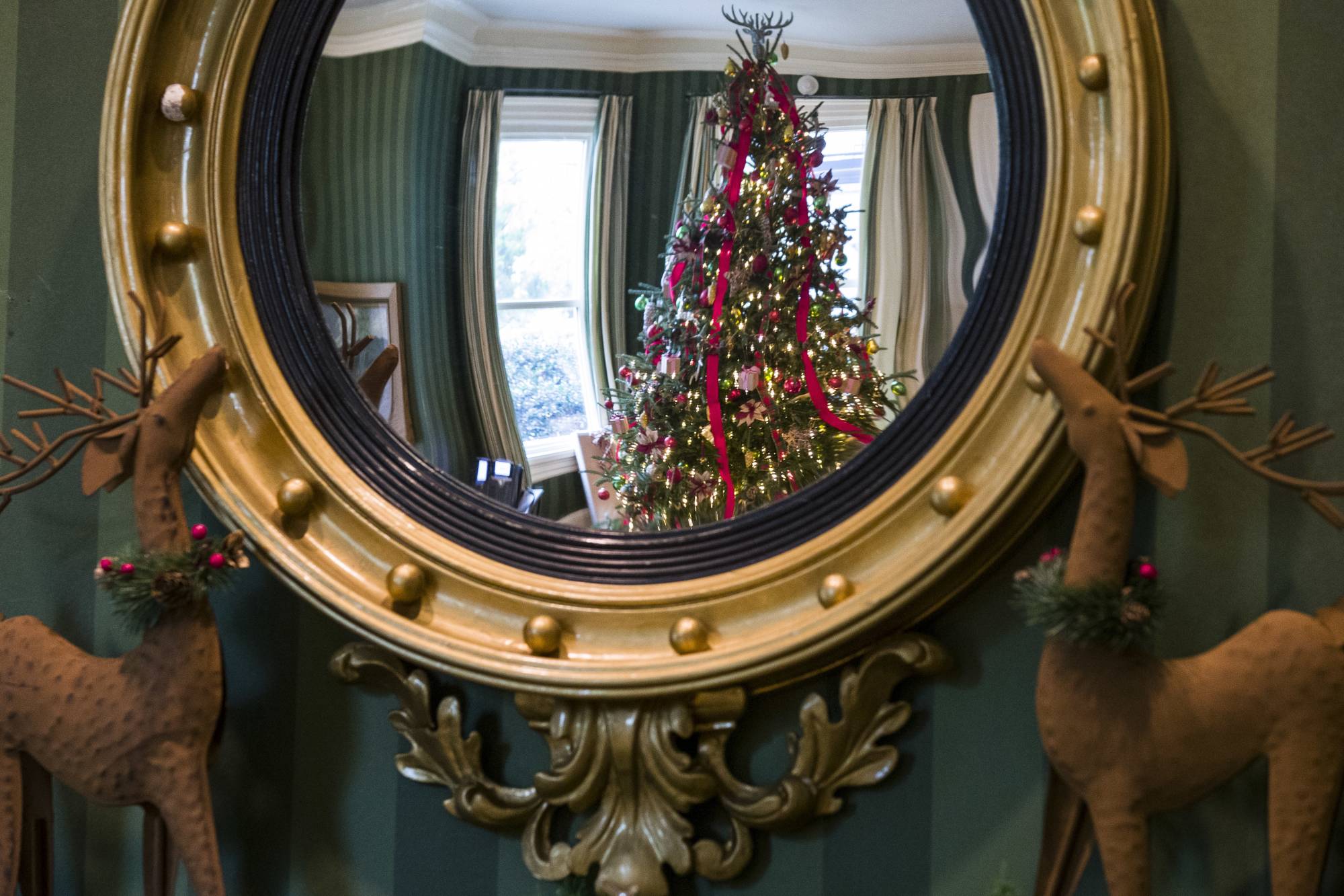 Holiday decorations are seen reflected in a mirror at the Vice President's residence, Thursday, Dec. 6, 2018, in Washington. (AP Photo/Alex Brandon)