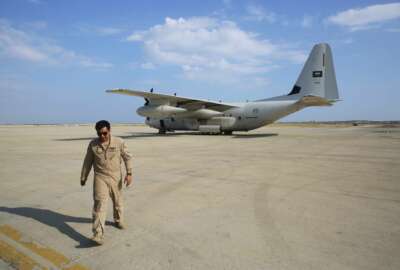 In this Wednesday, Nov. 28, 2018, photograph, an airman with the Royal Saudi Air Force walks away from a C-130 Hercules military cargo plane near Mukalla, Yemen, at an airport now serving as a military base for the United Arab Emirates. The port city of Mukalla, once held by al-Qaida, shows how fractious Yemen is and will remain even if the Saudi-led war in the country ends in an uneasy peace for the Arab world's poorest nation. (AP Photo/Jon Gambrell)