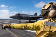 Aviation Boatswain’s Mate (Handling) 3rd Class Christian Cottman directs an F-35C Lightning II assigned to the “Argonauts” of Strike Fighter Squadron (VFA) 147 on the flight deck of Nimitz-class aircraft carrier USS Carl Vinson