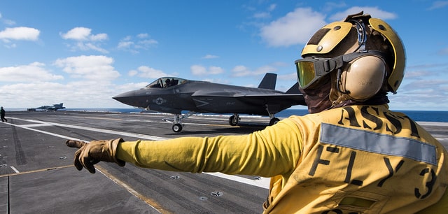 Aviation Boatswain’s Mate (Handling) 3rd Class Christian Cottman directs an F-35C Lightning II assigned to the “Argonauts” of Strike Fighter Squadron (VFA) 147 on the flight deck of Nimitz-class aircraft carrier USS Carl Vinson