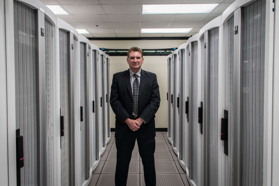 Ed Toner, Nebraska chief information officer, stands with servers.