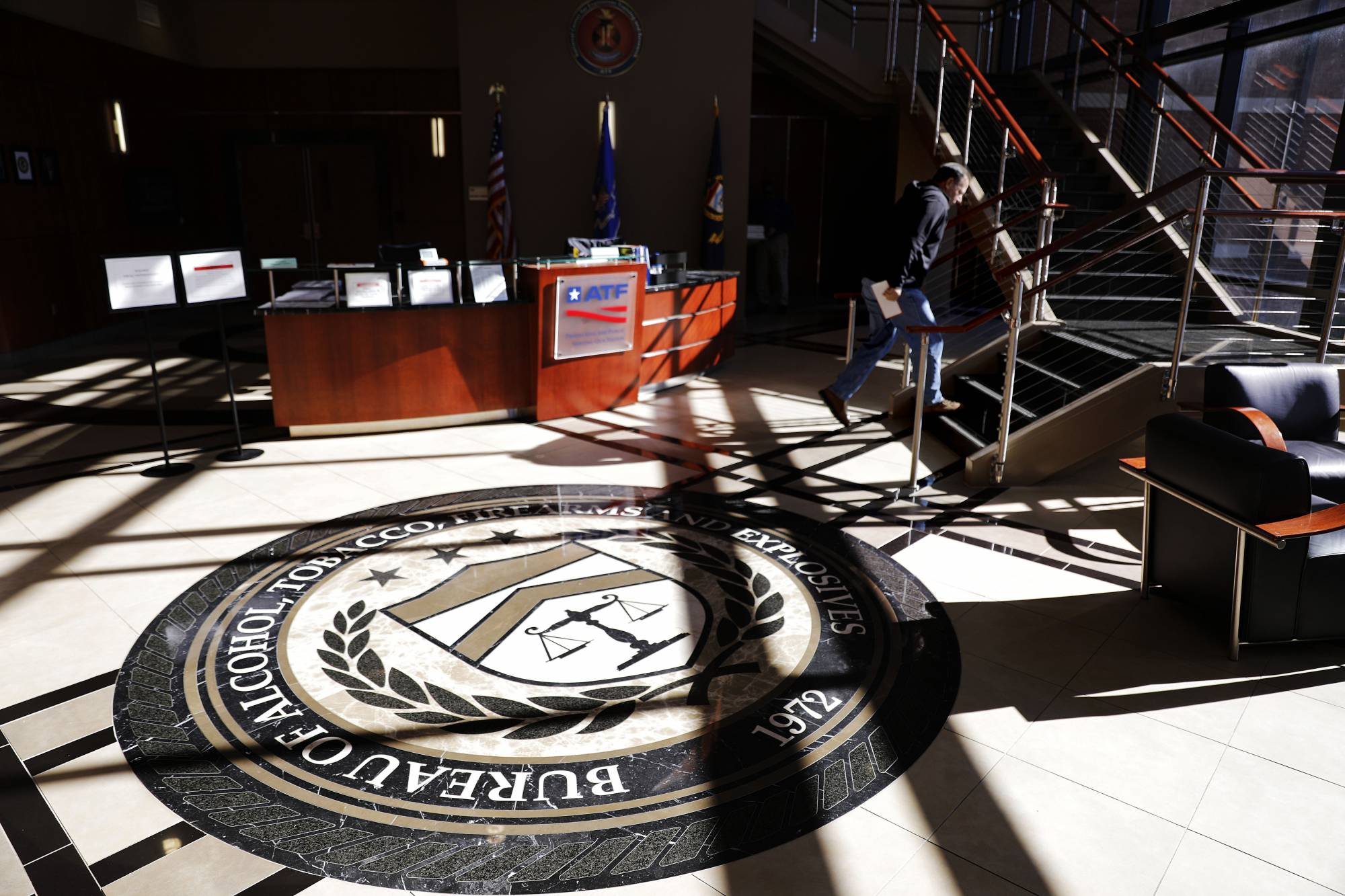 A worker walks through the empty lobby of the federal Bureau of Alcohol, Tobacco, Firearms and Explosives' National Center for Explosives Training and Research in Huntsville, Ala.
