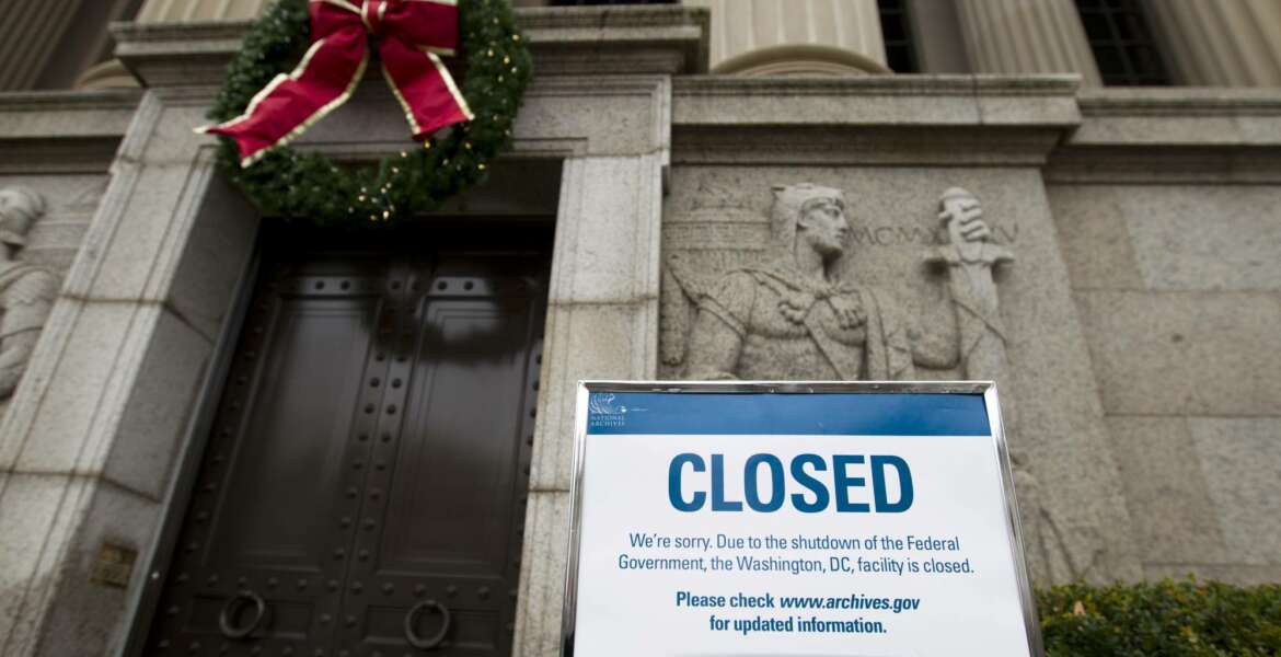 A closed sign is displayed at The National Archives entrance in Washington, Tuesday, Jan. 1, 2019, as a partial government shutdown stretches into its third week. A high-stakes move to reopen the government will be the first big battle between Nancy Pelosi and President Donald Trump as Democrats come into control of the House.  (AP Photo/Jose Luis Magana)