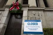 A closed sign is displayed at The National Archives entrance in Washington, Tuesday, Jan. 1, 2019, as a partial government shutdown stretches into its third week. A high-stakes move to reopen the government will be the first big battle between Nancy Pelosi and President Donald Trump as Democrats come into control of the House.  (AP Photo/Jose Luis Magana)