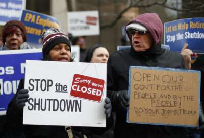 People rally to call for an end to the partial government shutdown in Detroit, Thursday, Jan. 10, 2019. (AP Photo/Paul Sancya)