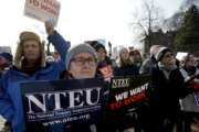 United States Department of Agriculture employee Lori Lodato, of Wilmington, Mass., display placards during a rally by federal employees and supporters, Thursday, Jan. 17, 2019, in front of the Statehouse in Boston, held to call for an end of the partial shutdown of the federal government. (AP Photo/Steven Senne)