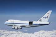 This undated photo provided by NASA shows SOFIA over the snow-covered Sierra Nevada mountains with its telescope door open during a test flight. The world's largest airborne observatory was supposed to be parked in Seattle this week, so thousands of scientists attending the "Super Bowl of Astronomy" could behold this marvel: a Boeing 747, like this one shown, for example, outfitted with a massive telescope used to study the fundamental mysteries of the universe. (Jim Ross/NASA via AP)