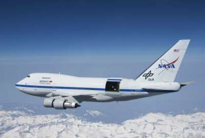 This undated photo provided by NASA shows SOFIA over the snow-covered Sierra Nevada mountains with its telescope door open during a test flight. The world's largest airborne observatory was supposed to be parked in Seattle this week, so thousands of scientists attending the 