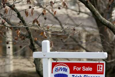 FILE - In this Jan. 3, 2019, file photo a realtor sign marks a home for sale in Franklin Park, Pa.  The partial federal government shutdown is complicating the already complicated process of getting and managing a mortgage. For one thing, the political storm is like severe weather at a major airport: You can expect minor delays or worse. Also, it could mean financial hardship for some federal government employees facing mortgage payments without their regular paychecks.  (AP Photo/Keith Srakocic)