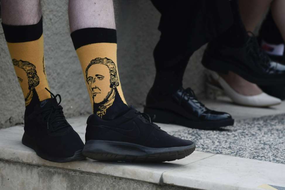 Scotland national Paul Mcque wears Hamilton socks in the entrance plaza of the Santurce Fine Arts Center moments before the premiere of the award-winning Broadway musical, Hamilton, starring its creator, New York native of Puerto Rican descent Lin-Manuel Miranda, in San Juan, Puerto Rico, Friday Jan. 11, 2019. The musical is set to run for two weeks and will raise money for local arts programs. (AP Photo/Carlos Giusti)